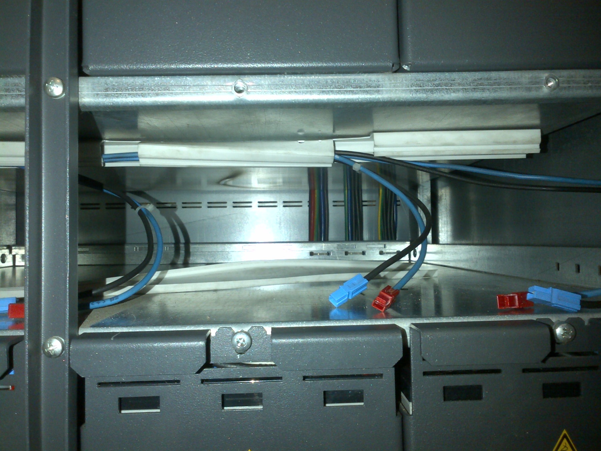 Battery compartment cabling and connectors visible during field-service work.