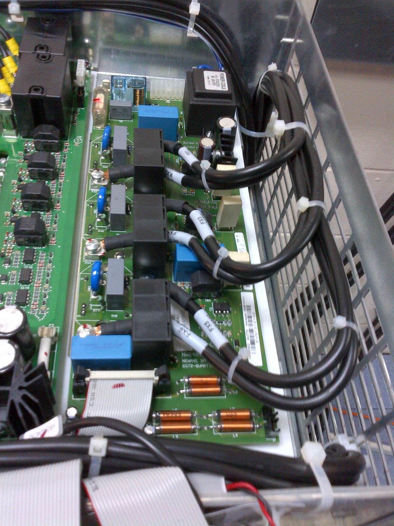 A close-up of internal UPS electronics, connectors and cable routing.